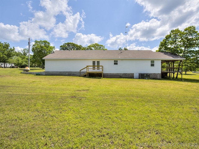 back of house with a yard, french doors, and central AC