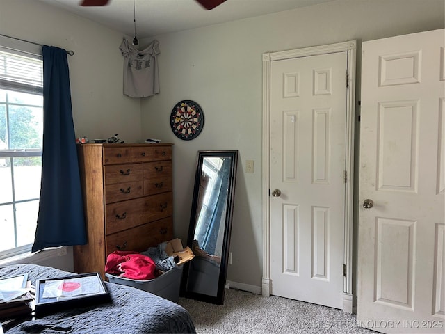 bedroom with light carpet and baseboards