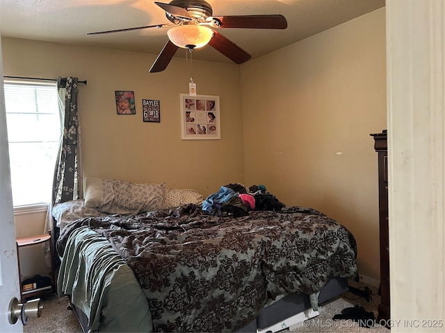 carpeted bedroom with a ceiling fan