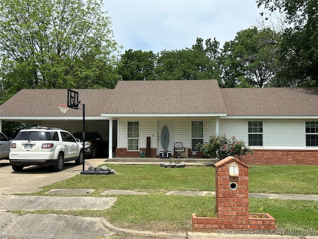 view of front of property featuring a carport, concrete driveway, a front lawn, covered porch, and brick siding