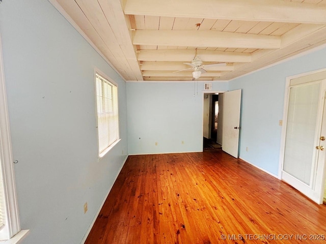 303 NW 3rd St, Stigler, OK 74462 - unfurnished room featuring beam ceiling, wooden ceiling, wood-type flooring, and ceiling fan