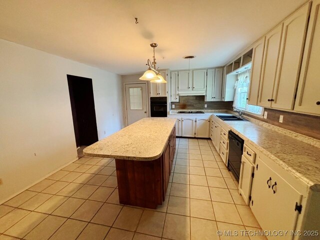 303 NW 3rd St, Stigler, OK 74462 - kitchen featuring black appliances, light tile patterned floors, a sink, a kitchen island, and light countertops