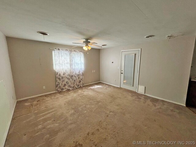 303 NW 3rd St, Stigler, OK 74462 - empty room with carpet, a ceiling fan, and baseboards