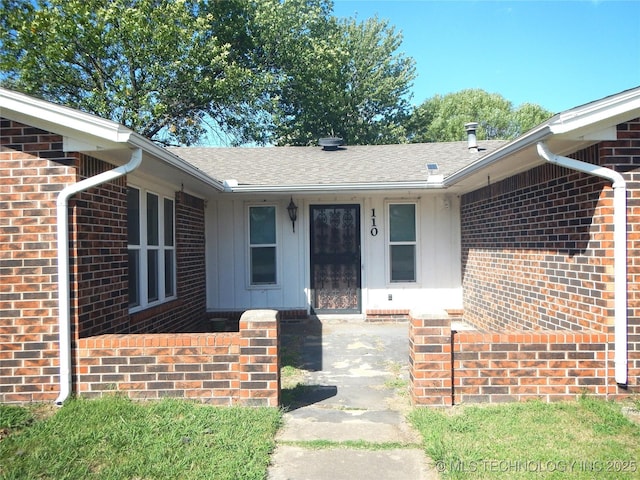 110 W 8th St, So Coffeyville, OK 74072 - entrance to property with brick siding, board and batten siding, and roof with shingles