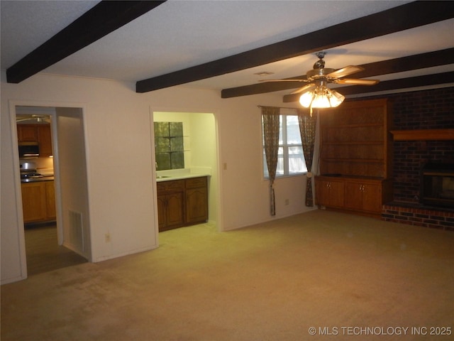 110 W 8th St, So Coffeyville, OK 74072 - unfurnished living room with beam ceiling, light carpet, a brick fireplace, and a ceiling fan