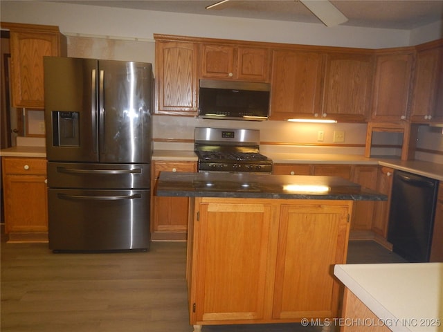110 W 8th St, So Coffeyville, OK 74072 - kitchen featuring appliances with stainless steel finishes, wood finished floors, and a kitchen island