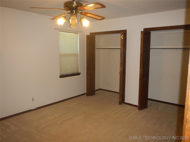 110 W 8th St, So Coffeyville, OK 74072 - unfurnished bedroom featuring light colored carpet, multiple closets, baseboards, and ceiling fan