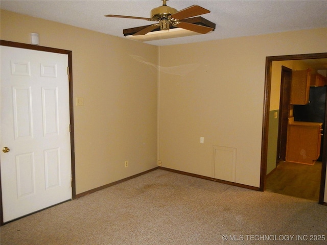 110 W 8th St, So Coffeyville, OK 74072 - empty room featuring light carpet, ceiling fan, and baseboards
