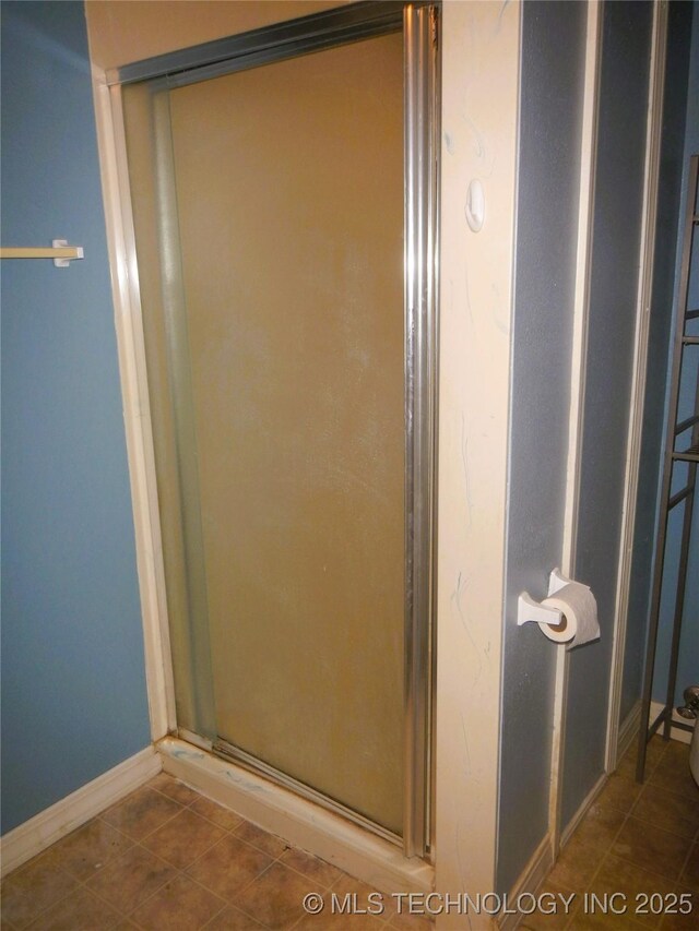 110 W 8th St, So Coffeyville, OK 74072 - bathroom with a shower stall, baseboards, and tile patterned floors