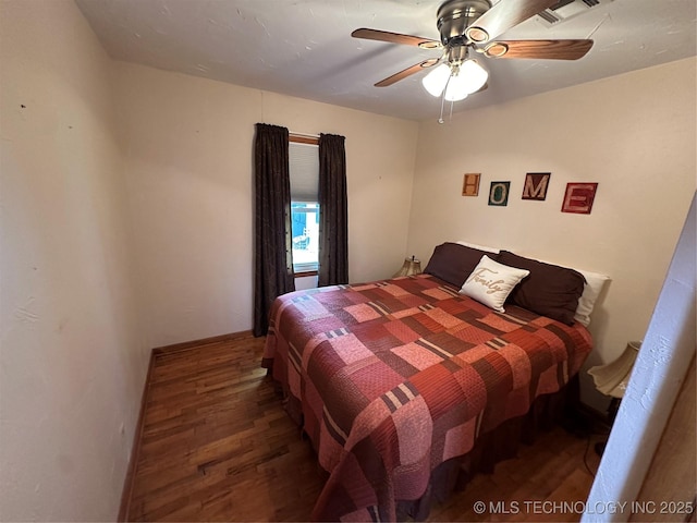 1002 Lakeland St, Checotah, OK 74426 - bedroom with wood finished floors and a ceiling fan