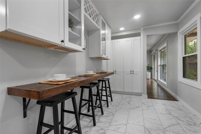 3478 S Gary Ave, Tulsa, OK 74105 - dining area with recessed lighting, crown molding, light marble finish flooring, and baseboards
