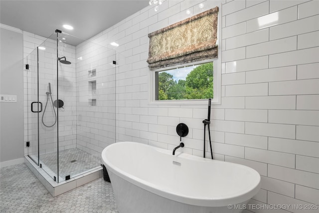 3478 S Gary Ave, Tulsa, OK 74105 - bathroom featuring a shower stall, a freestanding tub, tile patterned flooring, recessed lighting, and tile walls