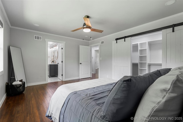 3478 S Gary Ave, Tulsa, OK 74105 - bedroom with a barn door, wood finished floors, baseboards, ornamental molding, and a ceiling fan