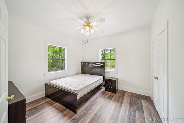1001 County Road 2265, Skiatook, OK 74070 - bedroom with multiple windows, baseboards, wood finished floors, and crown molding