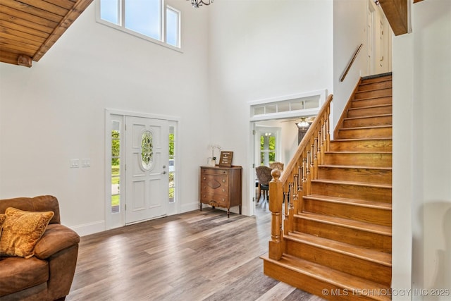1001 County Road 2265, Skiatook, OK 74070 - foyer entrance with a high ceiling, stairs, wood finished floors, baseboards, and wooden ceiling