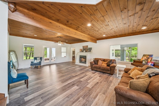 1001 County Road 2265, Skiatook, OK 74070 - living area with wood ceiling, wood finished floors, recessed lighting, a warm lit fireplace, and healthy amount of natural light