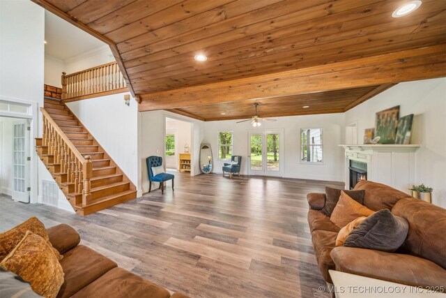 1001 County Road 2265, Skiatook, OK 74070 - living area with wood ceiling, a lit fireplace, wood finished floors, stairs, and ceiling fan