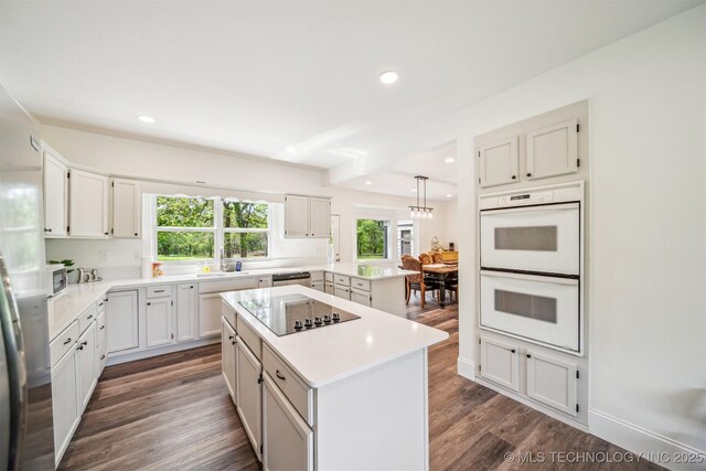 1001 County Road 2265, Skiatook, OK 74070 - kitchen with stainless steel appliances, a peninsula, light countertops, a center island, and recessed lighting