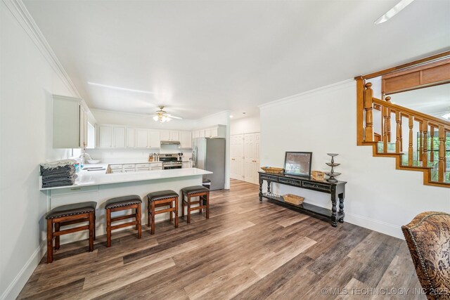 1001 County Road 2265, Skiatook, OK 74070 - kitchen featuring stainless steel appliances, a sink, a peninsula, a ceiling fan, and baseboards