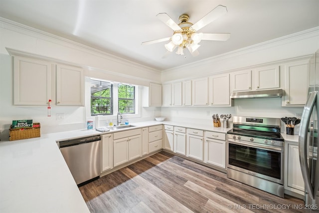 1001 County Road 2265, Skiatook, OK 74070 - kitchen featuring stainless steel appliances, a sink, under cabinet range hood, crown molding, and light countertops