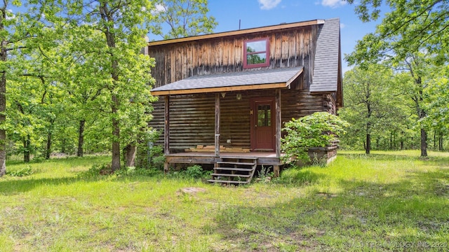 1001 County Road 2265, Skiatook, OK 74070 - rear view of house with log exterior, board and batten siding, and a wooden deck
