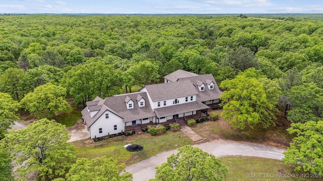 1001 County Road 2265, Skiatook, OK 74070 - aerial view of property and surrounding area with a heavily wooded area