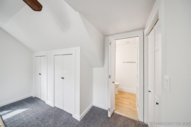 1001 County Road 2265, Skiatook, OK 74070 - unfurnished bedroom with dark colored carpet, multiple closets, baseboards, and ensuite bath