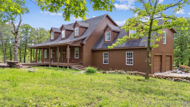 1001 County Road 2265, Skiatook, OK 74070 - rear view of property with a lawn, an attached garage, a shingled roof, a porch, and driveway