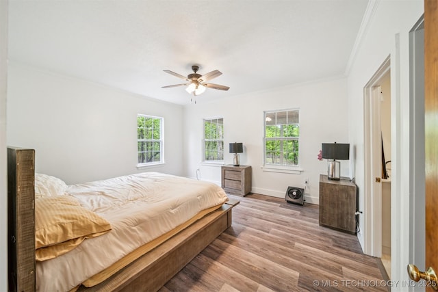 1001 County Road 2265, Skiatook, OK 74070 - bedroom featuring crown molding, multiple windows, light wood finished floors, baseboards, and a ceiling fan