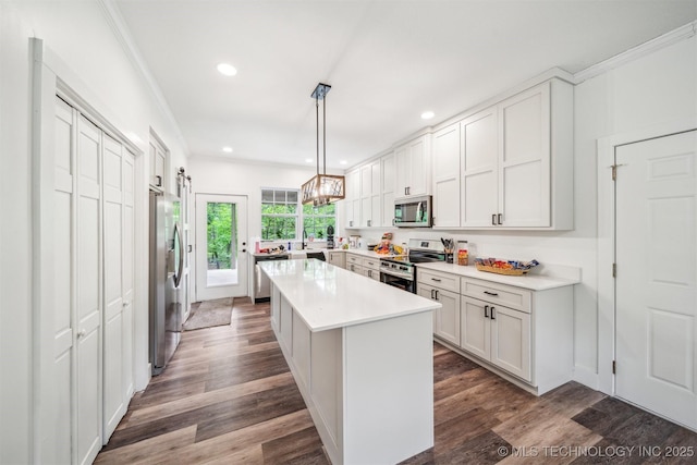 1001 County Road 2265, Skiatook, OK 74070 - kitchen with appliances with stainless steel finishes, recessed lighting, light countertops, a kitchen island, and ornamental molding