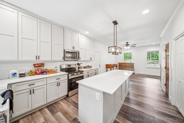 1001 County Road 2265, Skiatook, OK 74070 - kitchen with appliances with stainless steel finishes, wood finished floors, light countertops, a center island, and recessed lighting