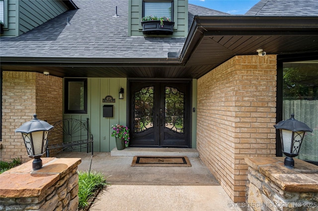 4728 S Atlanta Pl, Tulsa, OK 74105 - entrance to property with french doors, a shingled roof, brick siding, a security system, and covered porch