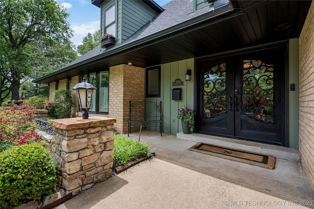 4728 S Atlanta Pl, Tulsa, OK 74105 - doorway to property featuring a shingled roof, french doors, a porch, and brick siding