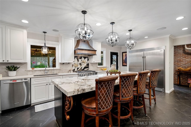4728 S Atlanta Pl, Tulsa, OK 74105 - kitchen featuring stainless steel appliances, a sink, premium range hood, tasteful backsplash, and recessed lighting