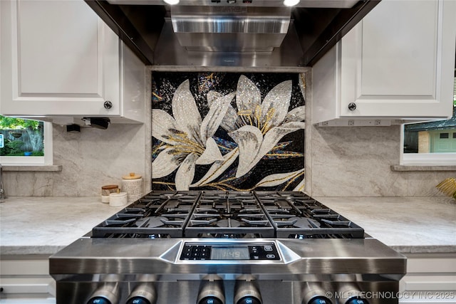 4728 S Atlanta Pl, Tulsa, OK 74105 - kitchen with range hood, decorative backsplash, light countertops, and white cabinetry