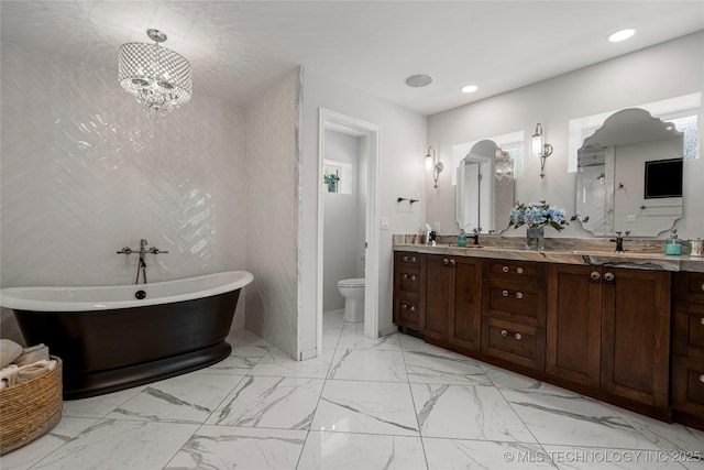 4728 S Atlanta Pl, Tulsa, OK 74105 - full bath featuring double vanity, a soaking tub, toilet, recessed lighting, and marble finish floors