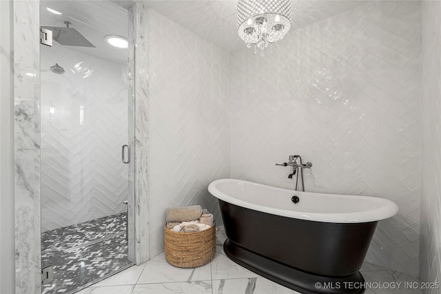 4728 S Atlanta Pl, Tulsa, OK 74105 - full bath with a stall shower, marble look tiles, a freestanding tub, and a chandelier