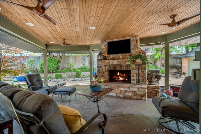 4728 S Atlanta Pl, Tulsa, OK 74105 - fenced backyard with an outdoor stone fireplace, ceiling fan, and a patio area