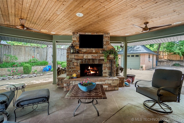 4728 S Atlanta Pl, Tulsa, OK 74105 - fenced backyard featuring an outdoor stone fireplace and a patio area