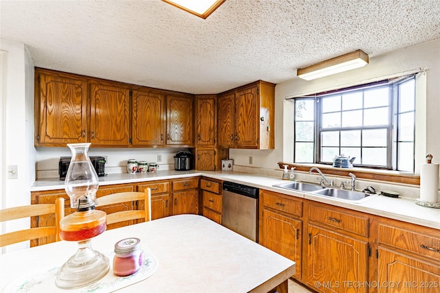 34047 W 191st St S, Bristow, OK 74010 - kitchen featuring stainless steel dishwasher, a sink, light countertops, brown cabinetry, and a textured ceiling