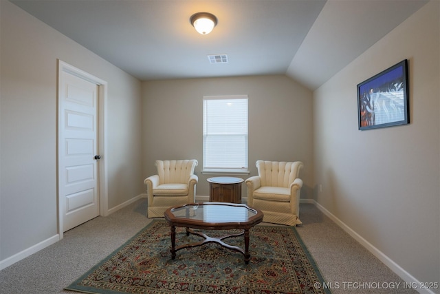 living area featuring carpet flooring, baseboards, and lofted ceiling