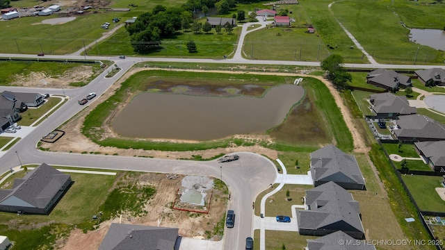 view of property location with a nearby body of water and nearby suburban area