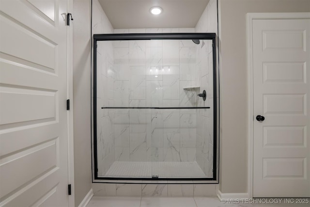 bathroom with a marble finish shower, baseboards, and recessed lighting