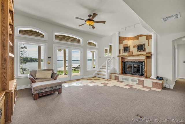 32290 S 630th Rd, Jay, OK 74346 - carpeted living area featuring french doors, a fireplace, a ceiling fan, baseboards, and a water view