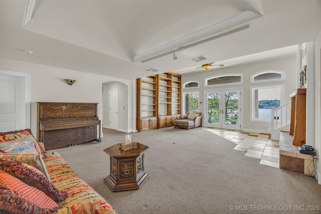 32290 S 630th Rd, Jay, OK 74346 - living room with arched walkways, built in shelves, carpet flooring, french doors, and a ceiling fan