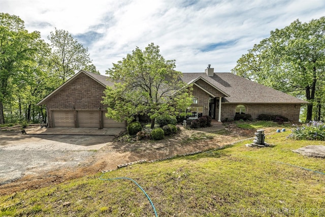 32290 S 630th Rd, Jay, OK 74346 - view of front of home featuring brick siding, a chimney, a garage, driveway, and a front lawn