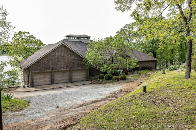 32290 S 630th Rd, Jay, OK 74346 - view of front of home with dirt driveway, roof with shingles, a garage, and brick siding