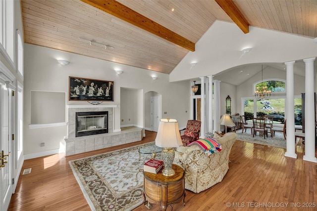 32290 S 630th Rd, Jay, OK 74346 - living area with decorative columns, arched walkways, beam ceiling, light wood-style flooring, and a chandelier