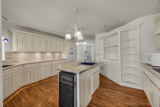 32290 S 630th Rd, Jay, OK 74346 - kitchen featuring a sink, beverage cooler, white appliances, wood finished floors, and backsplash