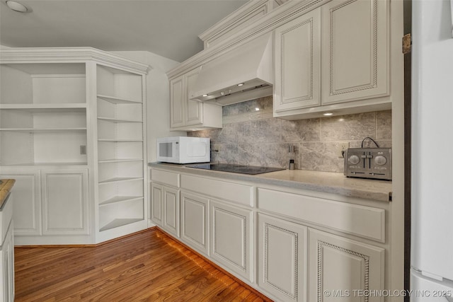 32290 S 630th Rd, Jay, OK 74346 - kitchen with white microwave, custom range hood, fridge, backsplash, and light wood-style floors